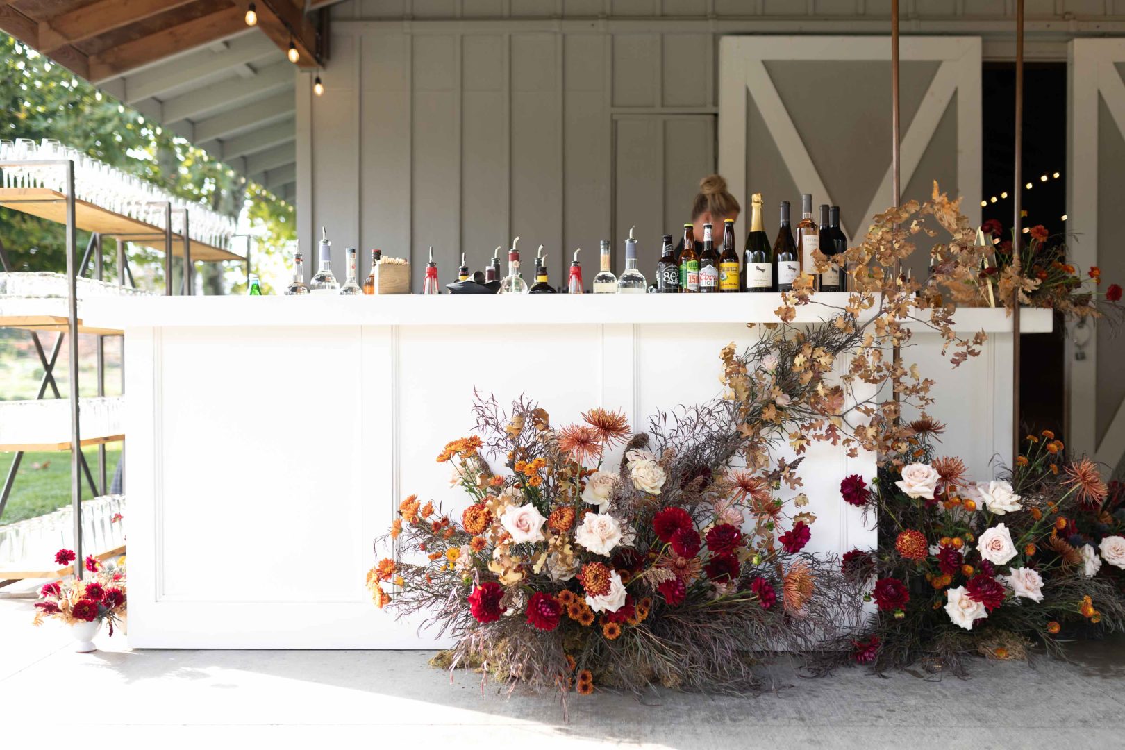 Outdoor venue bar with floral decorations